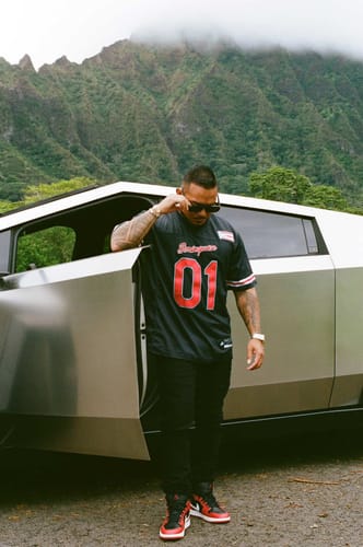 Reviewer standing outdoors wearing the black Puerto Rico Heritage Custom Football Jersey with red '01' detail.