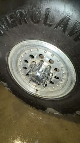 Customer's close-up of the chrome spike lug nuts installed on a silver truck wheel.