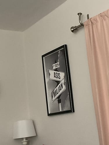 Customer's 'COUPLES DATE OF LOVE' canvas with the names 'Asis' and 'Milian' and year '2025' framed and hanging on a wall.