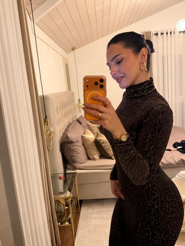 Reviewer taking a mirror selfie wearing the dark, bodycon Burnout Print Turtleneck Maxi Dress.