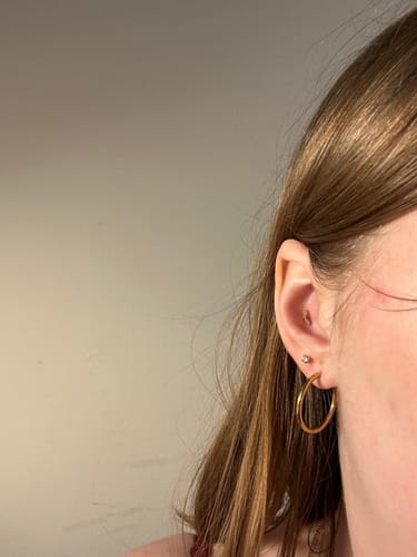 Customer wearing the Gilded leaf flatback Gold earring in their conch piercing.