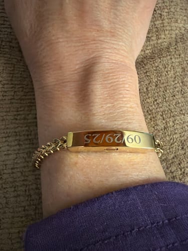 Reviewer wearing the engraved gold-tone Franco Link ID Urn Bracelet on their wrist.