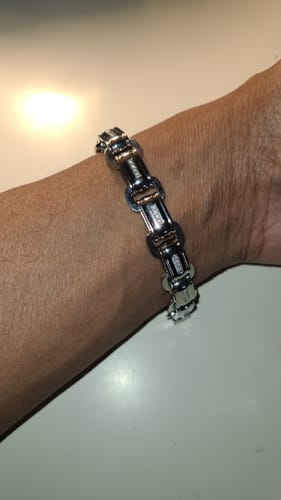 A reviewer's wrist wearing the shiny Stone-Set Link Bracelet against a white surface.