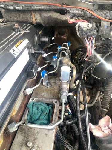 Customer's new Bosch CR Fuel Rail installed in a Cummins engine bay, showing connections and surrounding parts.