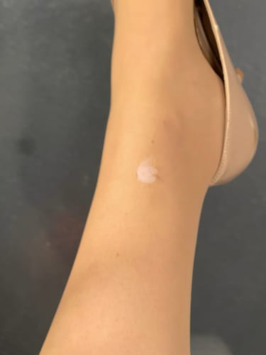 Close-up of a small hole forming on the sheer tights near the reviewer's ankle.