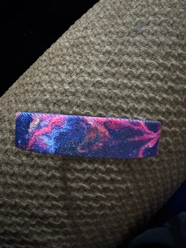Customer's Not Today, Anxiety Bracelet showing its vibrant galaxy pattern in blue and pink on a textured surface.