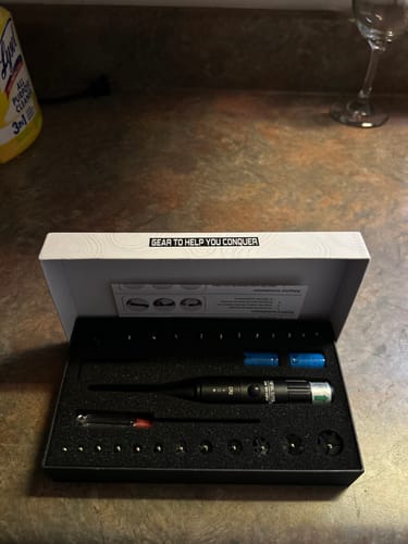 Customer's Site Right 2.0 Boresighter kit displayed in its open black case with accessories on a counter.