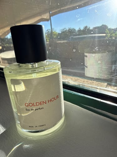 Customer's elegant Golden Hour perfume bottle sitting on a sunny windowsill.