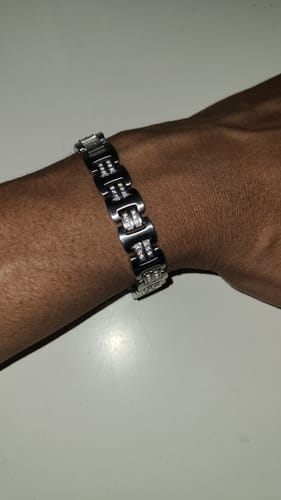 Customer showing the fit of the Rockstar Link Bracelet on their wrist. The shiny steel bracelet features stone-set links.