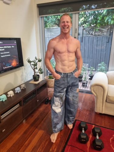 Customer showing the front fit of the wide-leg Vintage Patchwork Ripped Barrel Jeans in a living room.