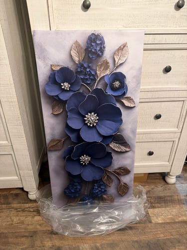 Customer's Modern Blossom Wall Art featuring large blue flowers and bronze leaves, shown in a bedroom.