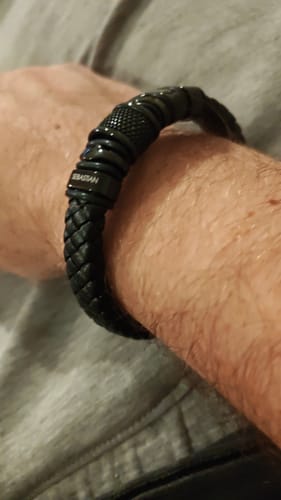 Customer wearing the personalized black bracelet on their wrist.