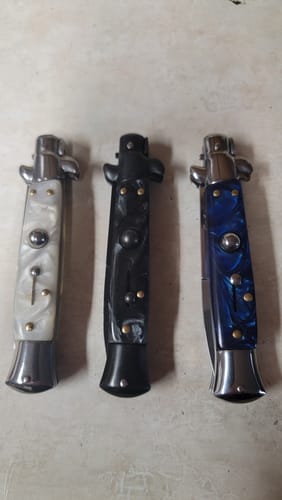 Customer's three folded Italian Style Push Button Switchblades with white, black, and blue marble handles.