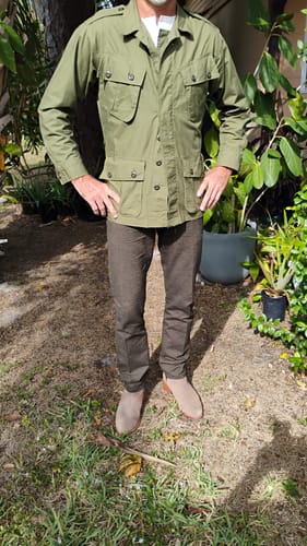 Reviewer showing the fit of the buttoned Tropical Jungle Fatigue Jacket while standing outdoors.