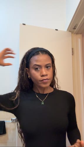 Reviewer showing the fit of the long-sleeved black NW Sculpt Crewneck Bodysuit.