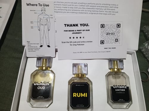 Reviewer's open box displaying three hexagonal perfume bottles from the OUD Supreme BUNDLE.