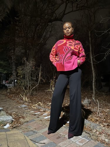Reviewer standing outdoors at night, showing the full length of the black NW Wide-leg Pant.