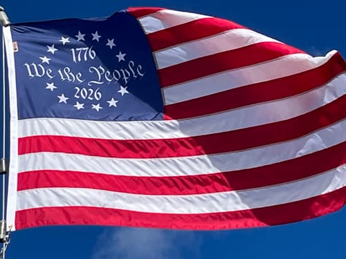 Customer's We The People Betsy Ross Flag with '1776' and '2026' text waving against a blue sky.