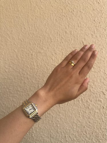 Reviewer wearing the elegant GREALY DE MAINS watch with a two-tone band on their wrist.