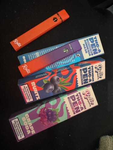 Customer's collection of colorful ROLLZ THCA Vape pens and their corresponding product boxes.