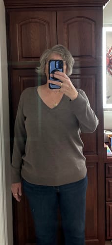 Reviewer provides a front view of the taupe Francesca Sweater, showing its v-neck design and relaxed fit.