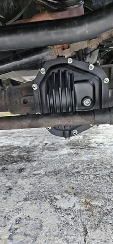 Customer's black SPE Motorsport Dana 60 Front Differential Cover installed on the front axle of their vehicle.