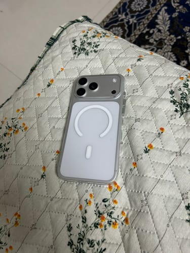 Reviewer's clear MagSafe case on a phone, showing the white magnetic ring and silver frame.
