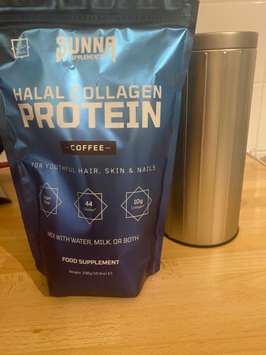 Customer's blue pouch of Collagen Coffee on a wooden counter next to a silver canister.