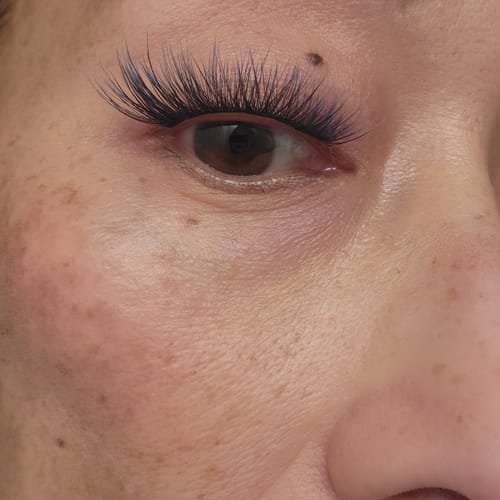 Customer's close-up of an eye wearing long Plushy Ombre Gossamer® Lashes, showing the subtle color gradient.