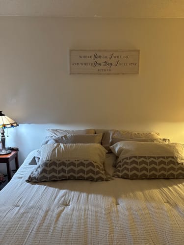 Customer's Tailored Boost canvas with a quote hanging on the wall above their bed.