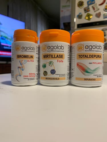 Un cliente mostra i tre flaconi di integratori del Pack Gambe Snelle su un tavolo.