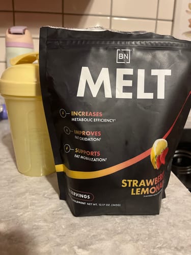 Customer's black pouch of Melt in Strawberry Lemonade flavor sits on a counter next to a yellow shaker bottle.