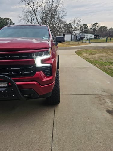 Customer's red Silverado truck with wheel spacers installed, showing the extended front wheel position.