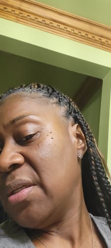 Close-up of a reviewer's face, showing their smooth skin after using the No More Grit Scrub.