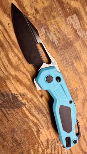 Customer's KETUO Mini Griffin G10 knife with a black spear point blade and a bright blue handle with black inlays.