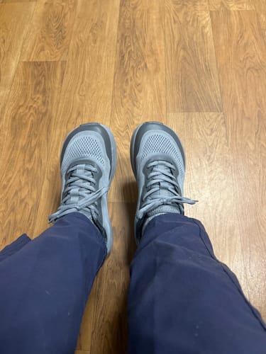Customer's top-down view of their gray MUUV City wide toe box shoes on a wood floor.