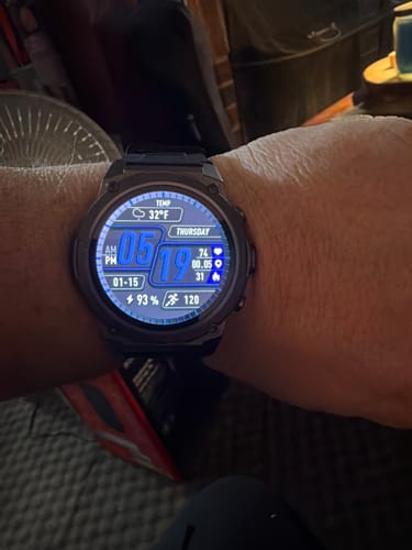 Reviewer's Gard Pro Ultra 3 smartwatch on their wrist, showing the bright digital display.