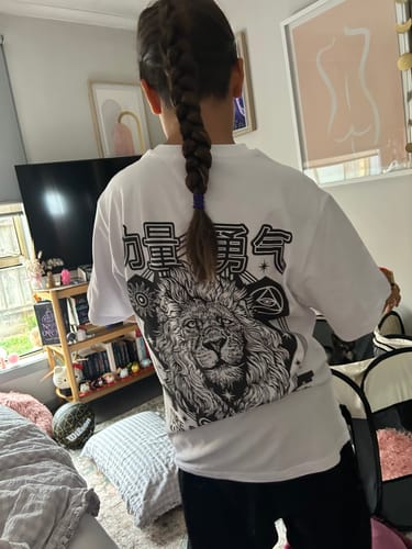 Customer from behind wearing the white Lion T-Shirt, showing the large black and white graphic print on the back.