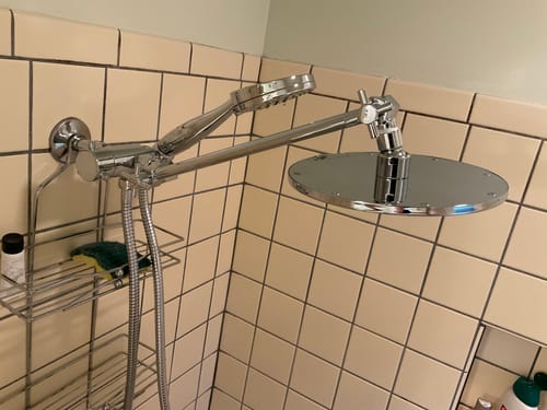 Customer's chrome 3-Spray Dual Shower Head installed in a tiled shower, showing the adjustable arm and both heads.