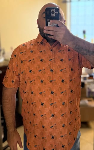 Reviewer wearing the orange, patterned NARUTO SHIPPUDEN 'Lil Arsenal' short-sleeve shirt.