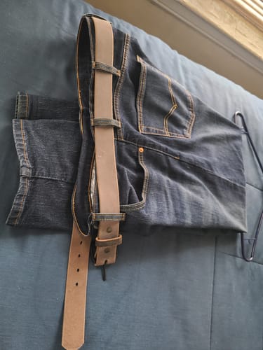 Reviewer's Glacier Grey Retro Style belt threaded through the loops of a pair of dark wash jeans.