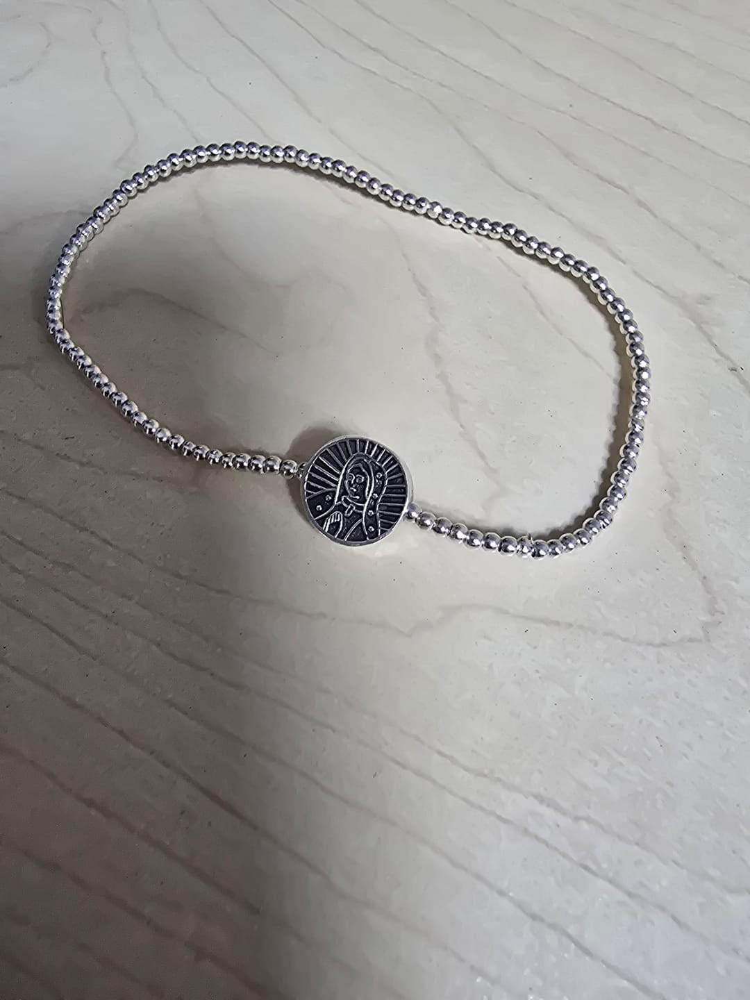 Customer photo review of 2 Pulseras San Benito y Virgen de Guadalupe