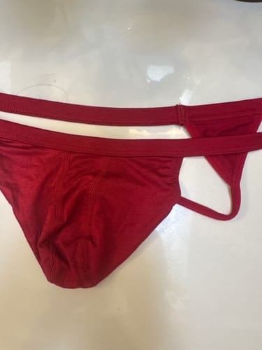 Customer's red Modal Thong laid out flat on a white surface.