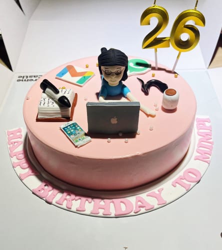 Customer's pink Workaholic Cake with fondant decorations of a person on a laptop, work icons, and '26' birthday candles.