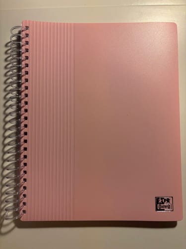 Le client montre le protège-documents OXFORD A5 rose pastel avec sa reliure à spirale.