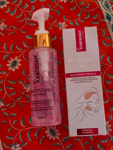 Customer's Pigmentation Bundle, showing the face wash and melasma cream box on a red floral surface.