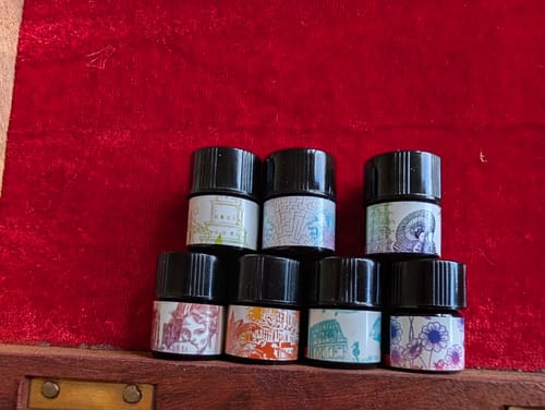 Customer's collection of small perfume sample vials with artistic labels, including the reviewed Chamomelia scent.