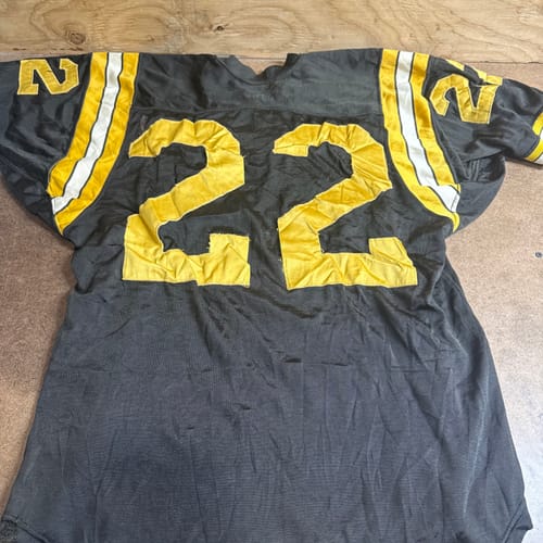Customer's B-grade black football jersey with yellow number 22, an example from the wholesale clothing mix.