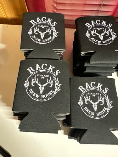 Customer's black can koozies showing a bright white print made with the DTF Super Soft Powder.