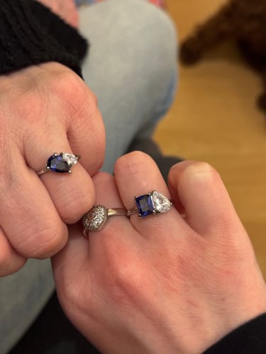 Customer showing two hands side-by-side, each wearing a matching Leesha Birthstone Ring.